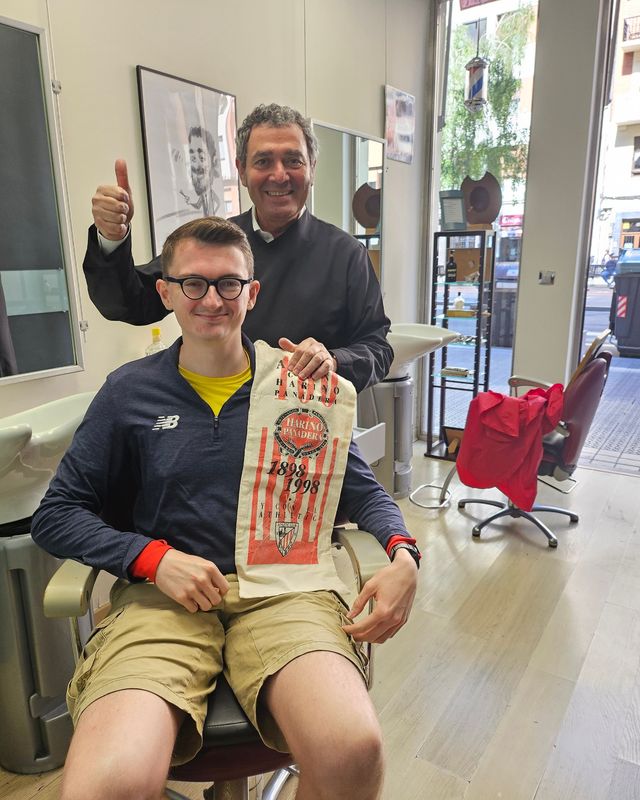 Henry with a barber in Bilbao