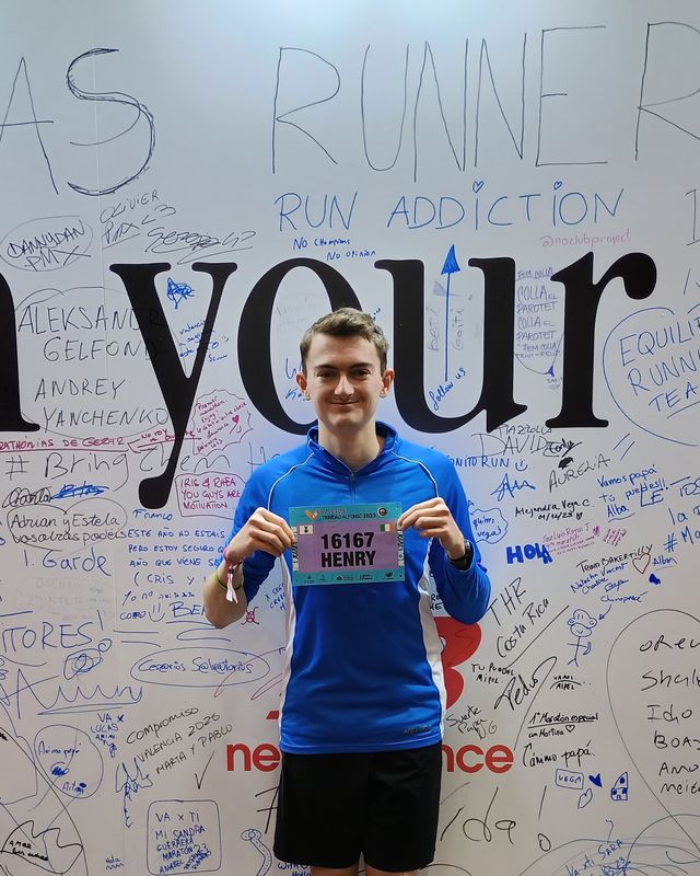 Henry holding his Valencia Marathon race number